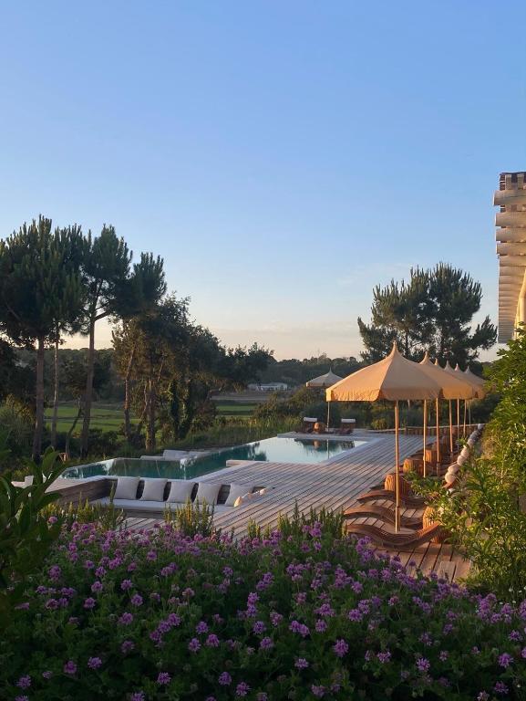 Luxury Alentejo hotel with pool, sun loungers and gardens at dusk