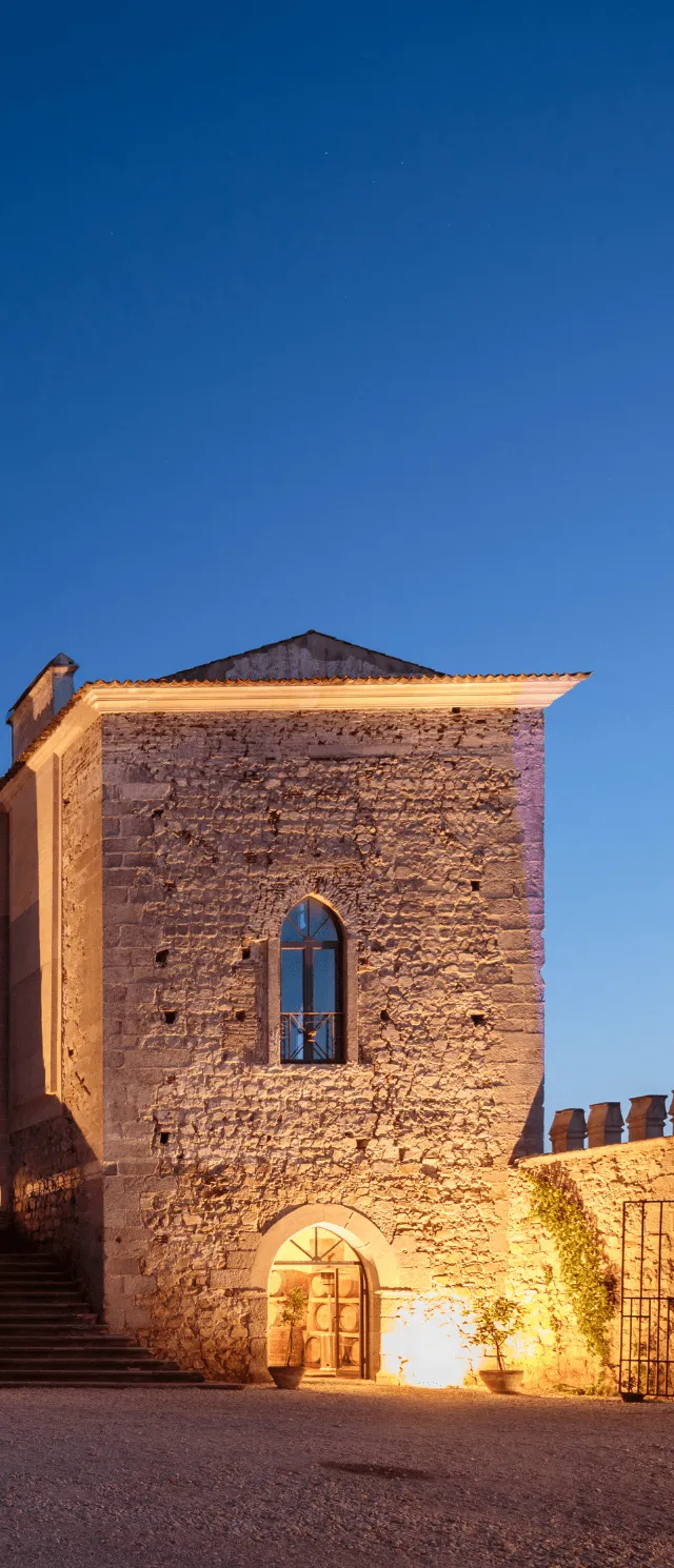 Stone tower of an Alentejo wine estate lit at dusk